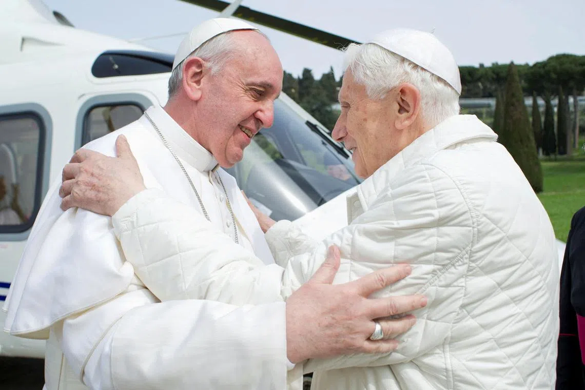 Pope Francis (left) will be the first pope in modern history to preside over the funeral of his predecessor, Benedict XVI (right).