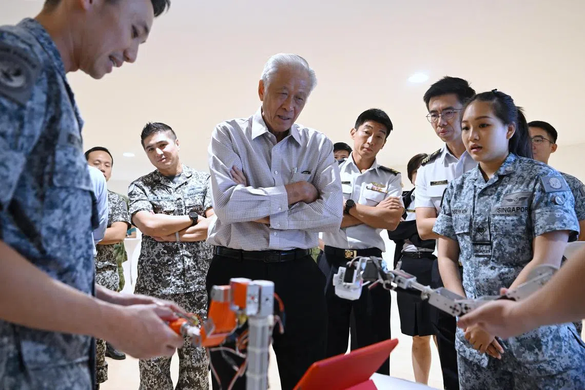 Minister for Defence Dr Ng Eng Hen at a booth at the IIS23 awards presentation ceremony checking out SwiftEye which can be used to inspect fuel tank on chinook helicopters.