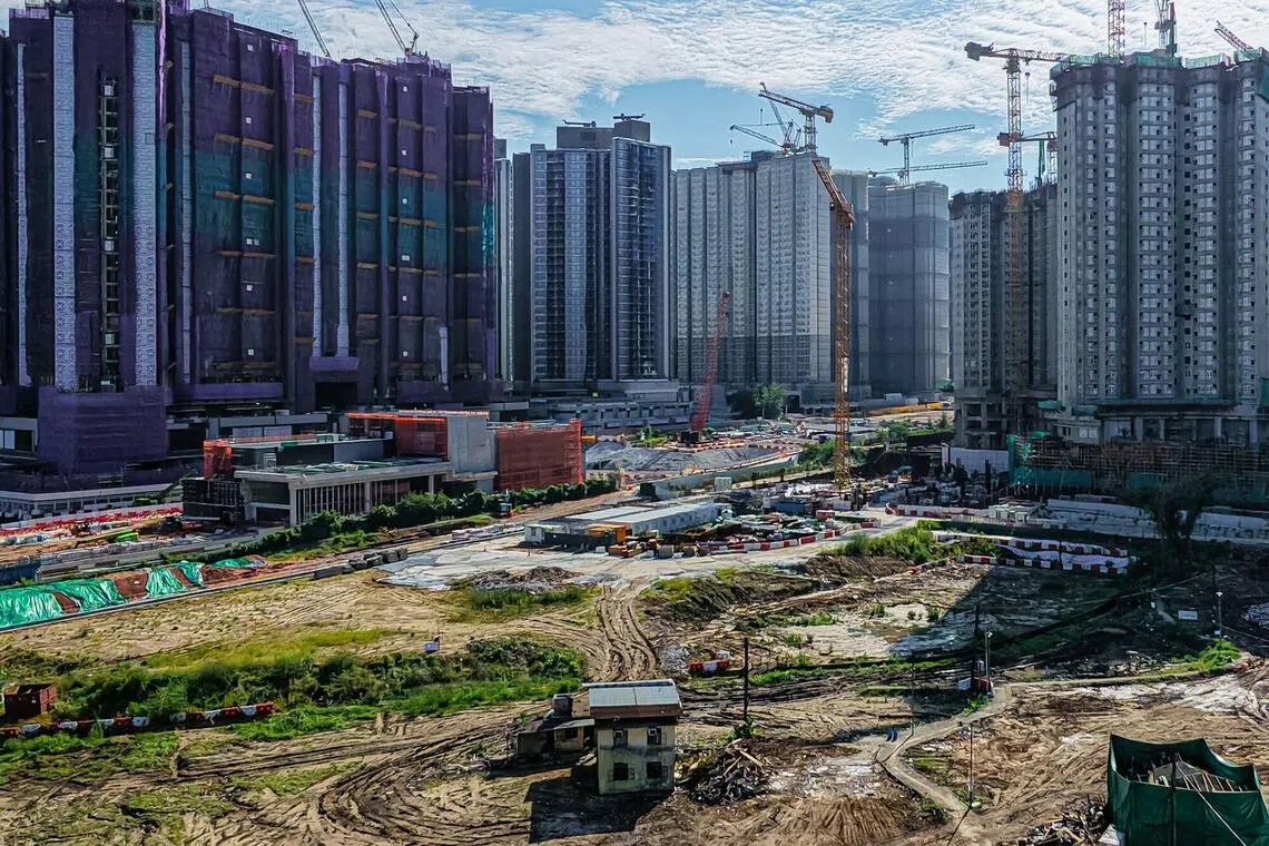 Residential buildings under construction beyond a now-demolished village house in Hong Kong’s Kwu Tung area, as part of the Northern Metropolis development plan.