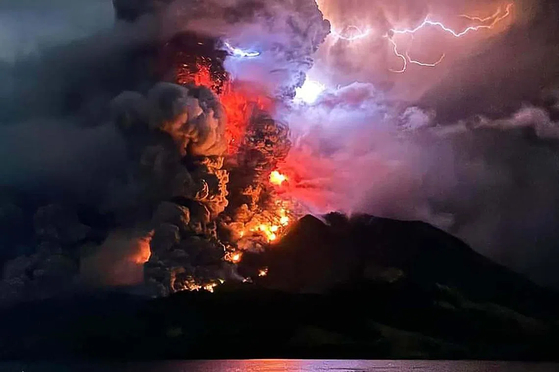 Mount Ruang spewing hot lava and smoke as seen from Sitaro, North Sulawesi. The volcano erupted several times in Indonesia's outermost region overnight on April 17, 2024, forcing hundreds of people to be evacuated after it spewed lava and a column of smoke into the sky. 