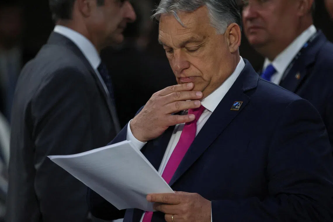 FILE PHOTO: Hungary's Prime Minister Viktor Orban reads a document during NATO's 75th anniversary summit, in Washington, U.S., July 11, 2024. REUTERS/Leah Millis/File Photo