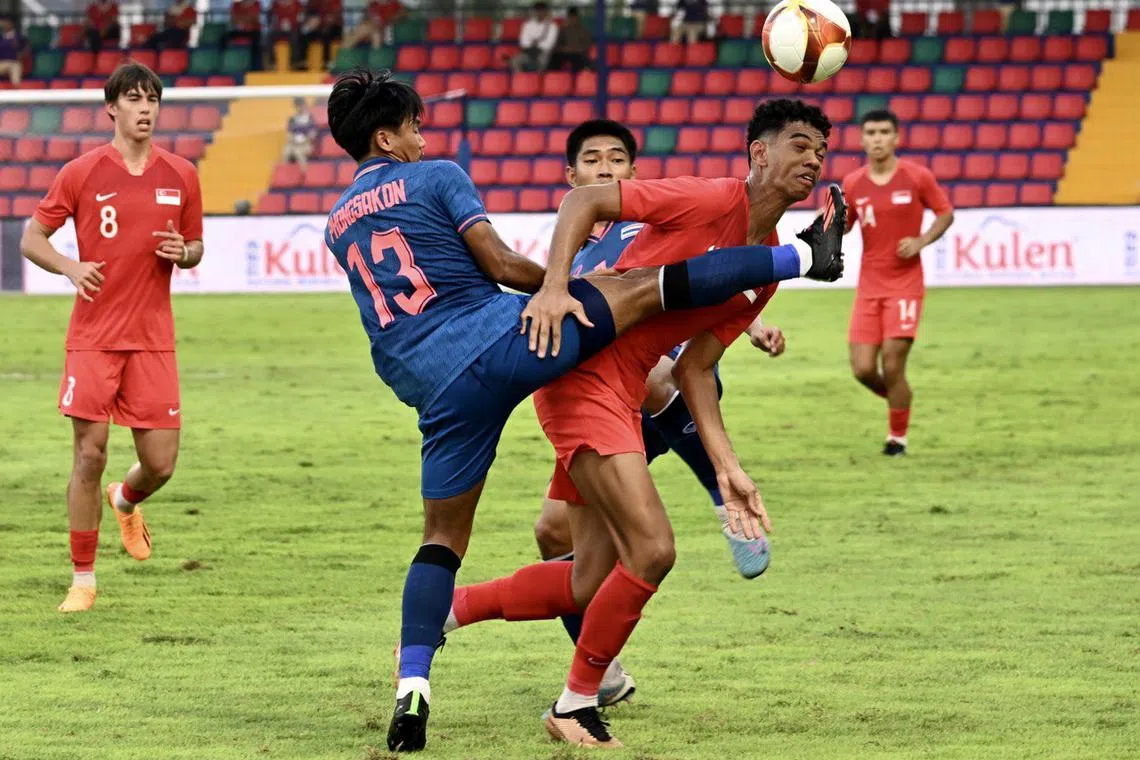 Thailand's Phongsakon Trisat (No. 13) trying to stop Singapore's Jordan Emaviwe, while captain Harhys Stewart (No. 8) looks on.