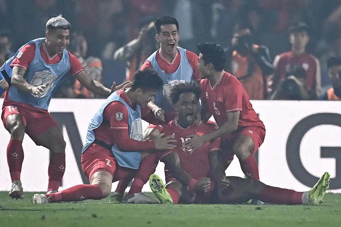 Vietnam's forward Rafaelson celebrating with teammates after scoring a goal during the 2-1 Asean Championship final, first -leg win over Thailand at the Viet Tri Stadium in Phu Tho province on Jan 2.