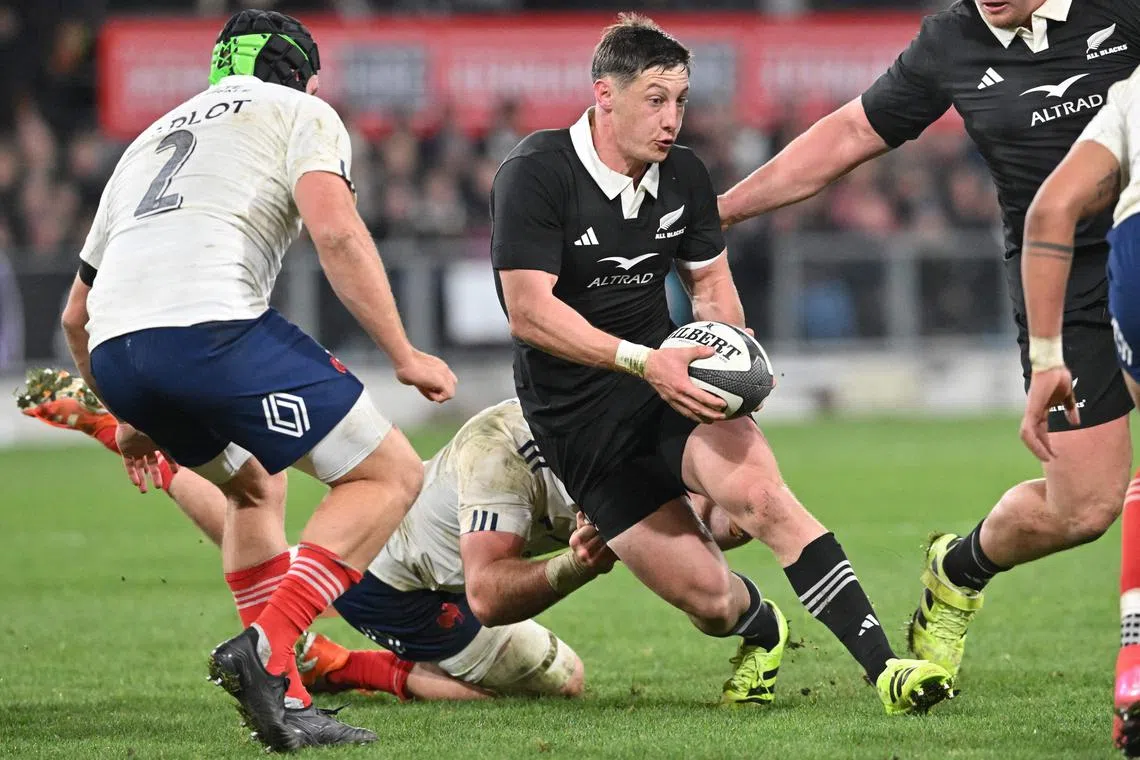 New Zealand's Cam Roigard is tackled in the first international rugby Test match against France at Forsyth Barr Stadium in Dunedin on July 5, 2025.