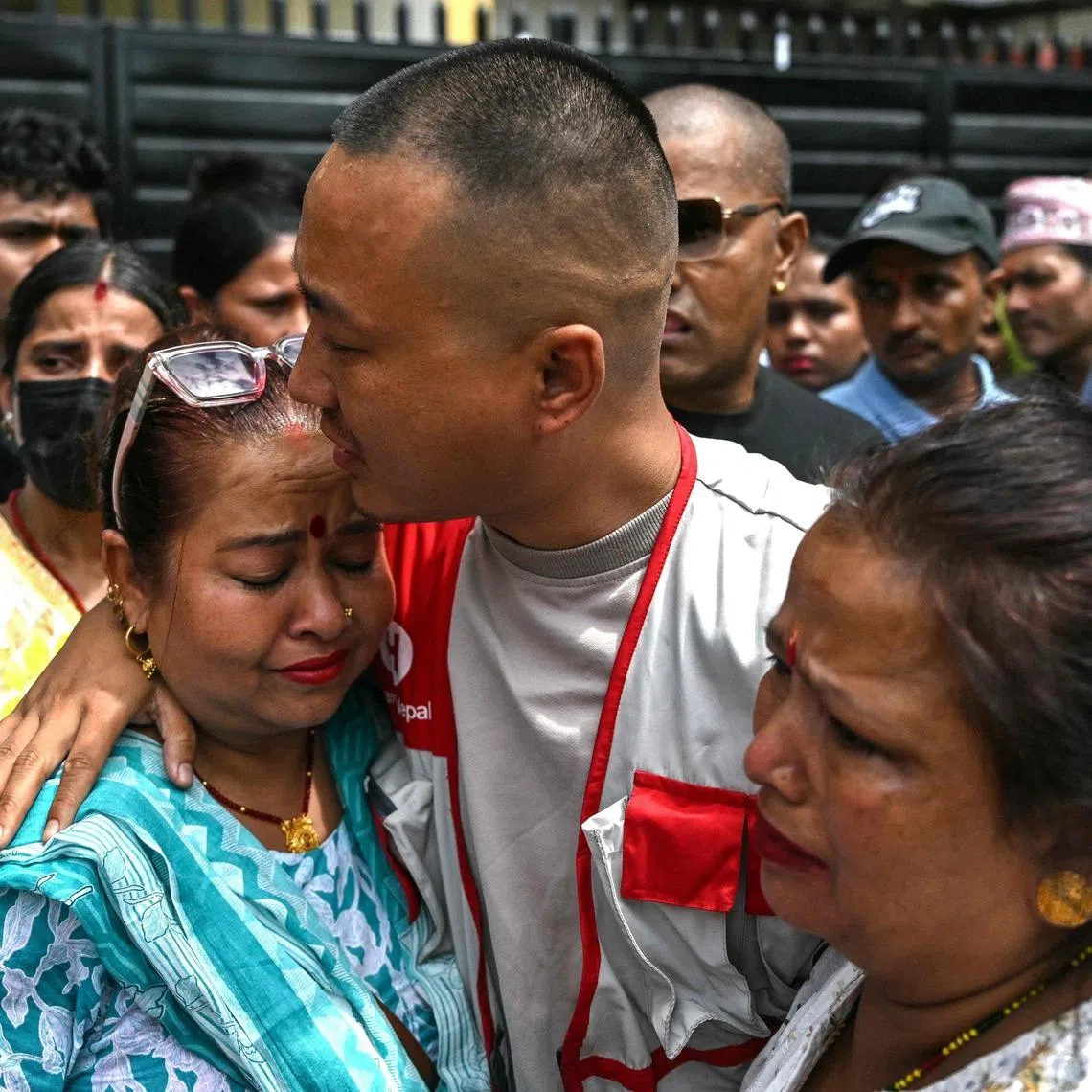 Sudan Gurung (centre), a key figure among the Gen Z protesters, meets with family members of a victim, who died during anti-corruption clashes with security personnel.