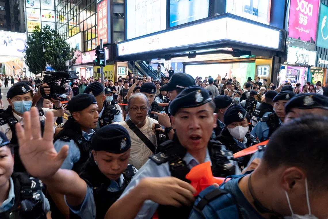 Police arresting performance artist Sanmu Chen (centre) in Causeway Bay near Victoria Park in Hong Kong on Saturday, a day before the anniversary of the 1989 Tiananmen Square crackdown.