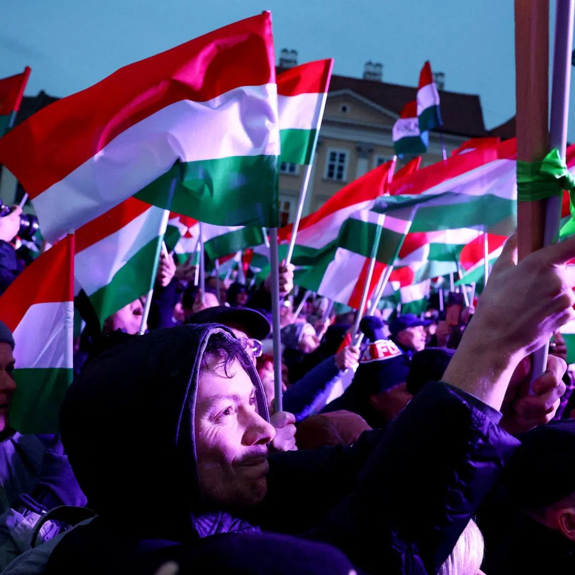 FILE PHOTO: People listen to the speech of the Hungarian Prime Minister Viktor Orban, not pictured, during an election campaign rally in Gyor, Hungary, March 27, 2026. REUTERS/Bernadett Szabo/File Photo