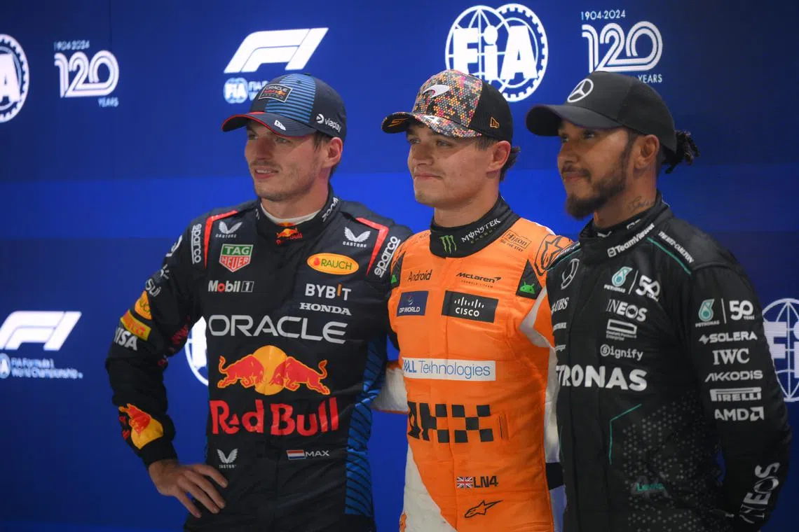 Pole position sitter British driver Lando Norris (centre) of McLaren F1 Team with the other top two qualifers Dutch driver Max Verstappen (left) of Red Bull Racing and British driver Lewis Hamilton of Mercedes-AMG Petronas, posing for a group picture after the qualifying round of the Formula One Singapore Airlines Singapore Grand Prix, on Sept 21, 2024.