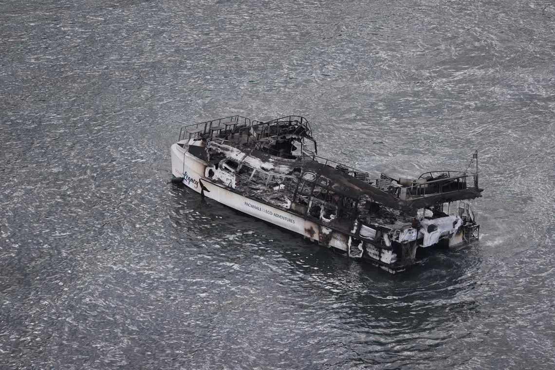 A burned out boat is seen in the waters fronting Lahaina on Aug 10, 2023. 