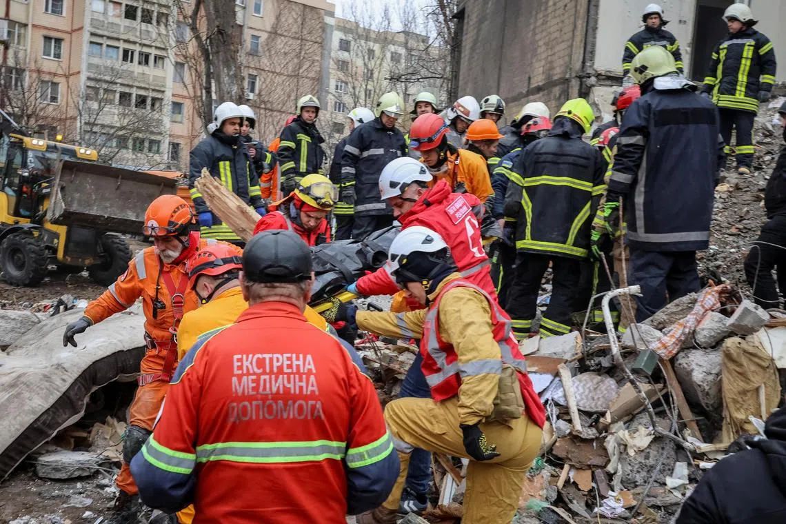 Rescuers remove the body of a local resident at the site of a residential building heavily damaged by a Russian drone strike, amid Russia's attack on Ukraine, in Odesa, Ukraine March 2, 2024. REUTERS/Stringer