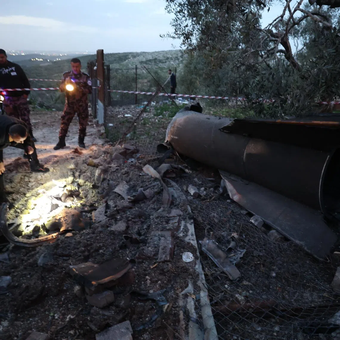 Palestinian officials inspecting the remains of a ballistic missile that landed in Anza village, near the West Bank city of Jenin, on March 20.