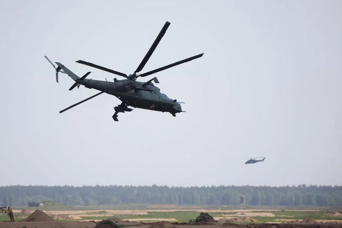 FILE PHOTO: Polish Mi-24 helicopters flight during Defender Europe 2022 military exercise of NATO troops including French, American, and Polish troops, amid the Russian invasion of Ukraine, at the military range in Bemowo Piskie, near Orzysz, Poland May 24, 2022. REUTERS/Kacper Pempel