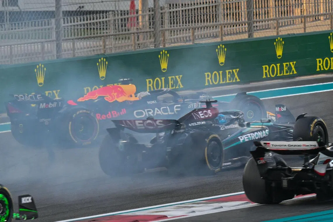 Red Bull's Dutch driver Max Verstappen (left) driving on after a collision with McLaren's Australian driver Oscar Piastri during the Abu Dhabi Grand Prix at the Yas Marina Circuit on Dec 8.