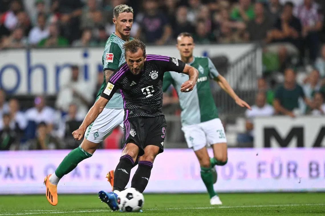 Bayern Munich's Harry Kane shoots to score his team's second goal, in a 4-0 away win over Bremen.