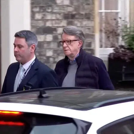 Former British Ambassador to the US Peter Mandelson being led away from his home by a police officer in London, Britain, on Feb 23, 2026, in this screen capture from video. 