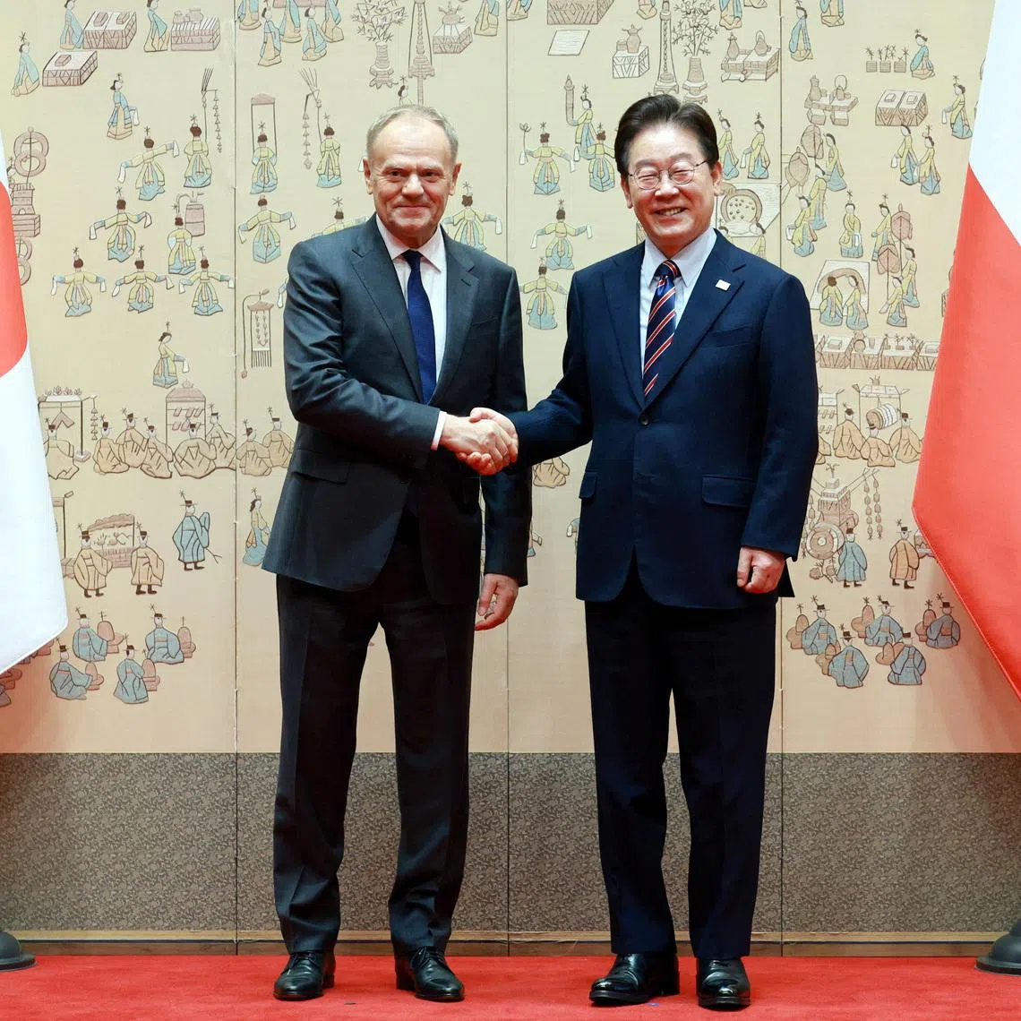 Polish Prime Minister Donald Tusk and South Korean President Lee Jae Myung pose for photographs before their meeting at the Presidential Blue House in Seoul, South Korea, April 13, 2026. Yonhap via REUTERS
