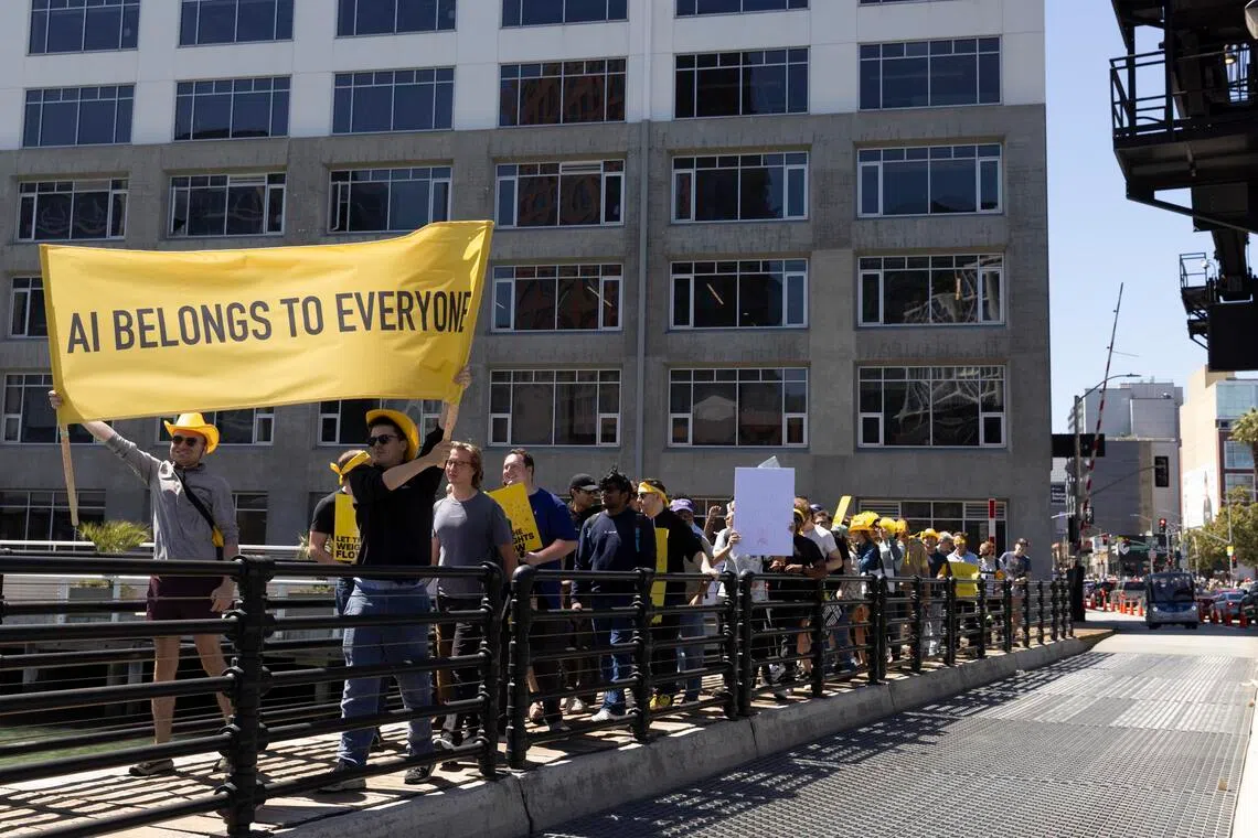 Demonstrators hold a sign that reads ‘AI Belongs to Everyone’ during the Open Weights Mini March in San Francisco, on July 25.