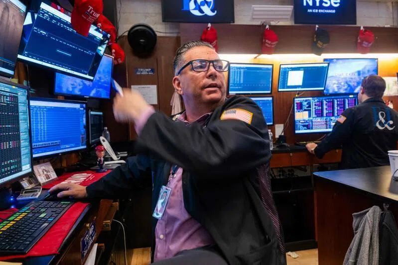 Traders work on the floor of the New York Stock Exchange on Oct 13.
