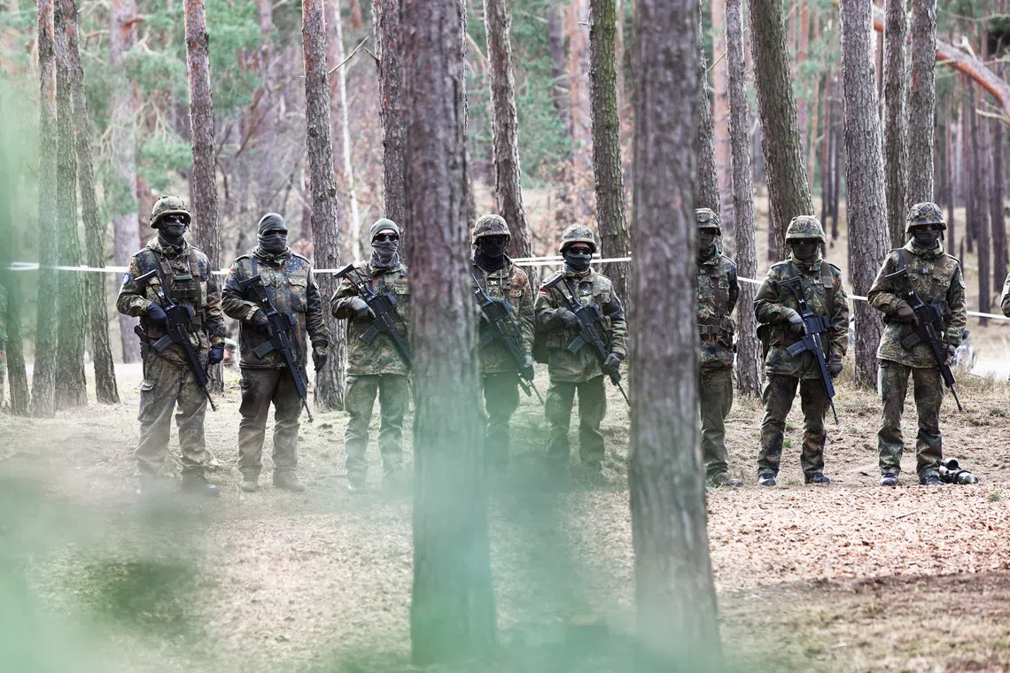 Soldiers stand in line at a training site as they undergo maintenance training on Leopard 1 A5 tanks, at the German army Bundeswehr base, part of the EU Military Assistance Mission in support of Ukraine (EUMAM UA) in Klietz, Germany, February 23, 2024. REUTERS/Liesa Johannssen