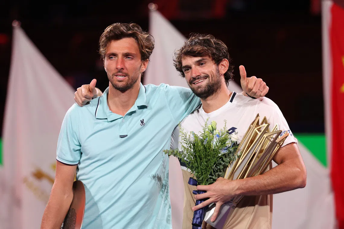 Tennis - ATP Masters 1000 - Shanghai Masters - Qizhong Forest Sports City Arena, Shanghai, China - October 12, 2025 Monaco's Valentin Vacherot celebrates with the trophy and France's Arthur Rinderknech after winning the final REUTERS/Go Nakamura