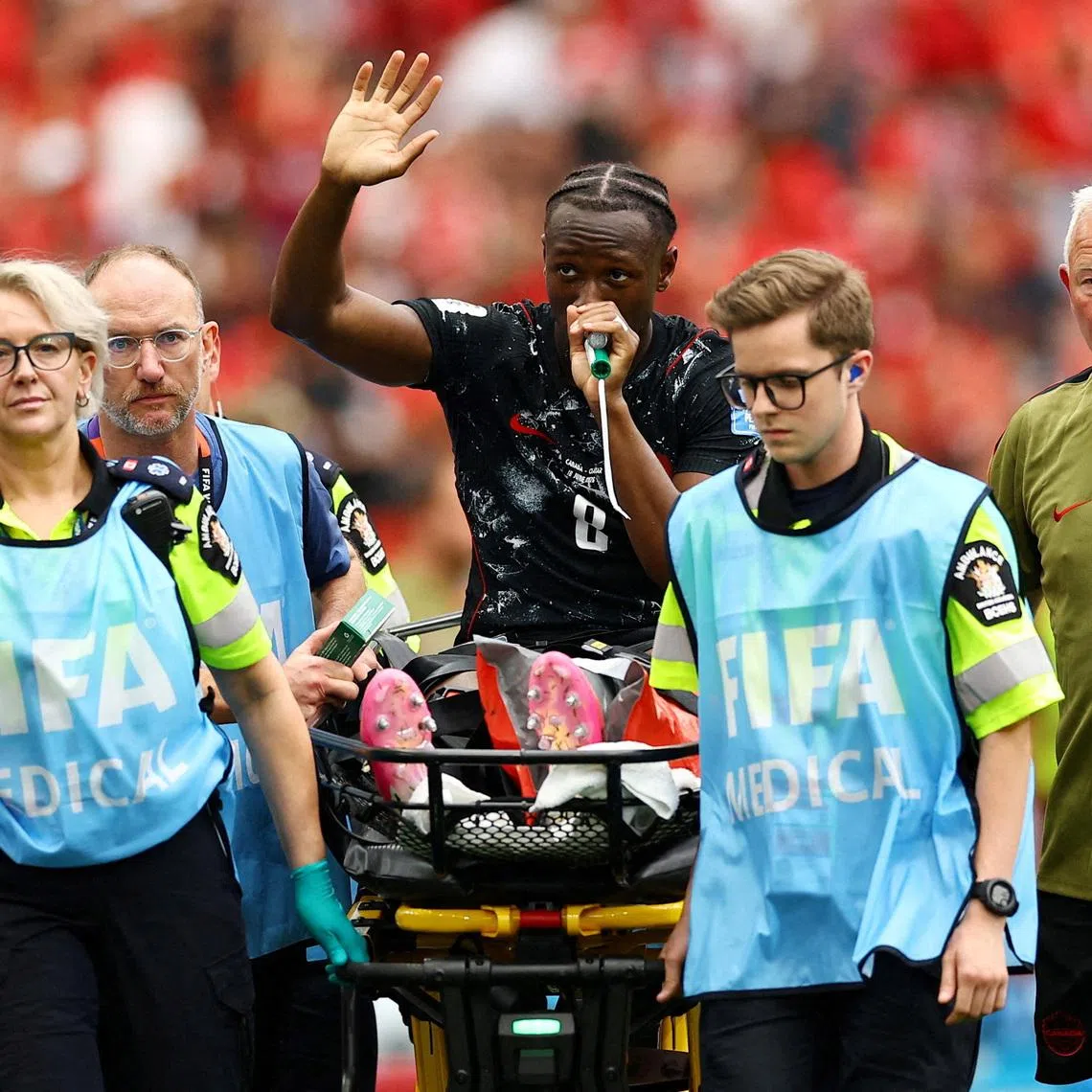 Soccer Football - FIFA World Cup 2026 - Group B - Canada v Qatar - BC Place, Vancouver, Canada - June 18, 2026. Canada's Ismael Kone waves to the crowd as he uses a \"green whistle\" (Penthrox), a portable, self-administered inhaler used by paramedics for fast-acting pain relief, after sustaining an injury and being stretchered off. REUTERS/Agustin Marcarian