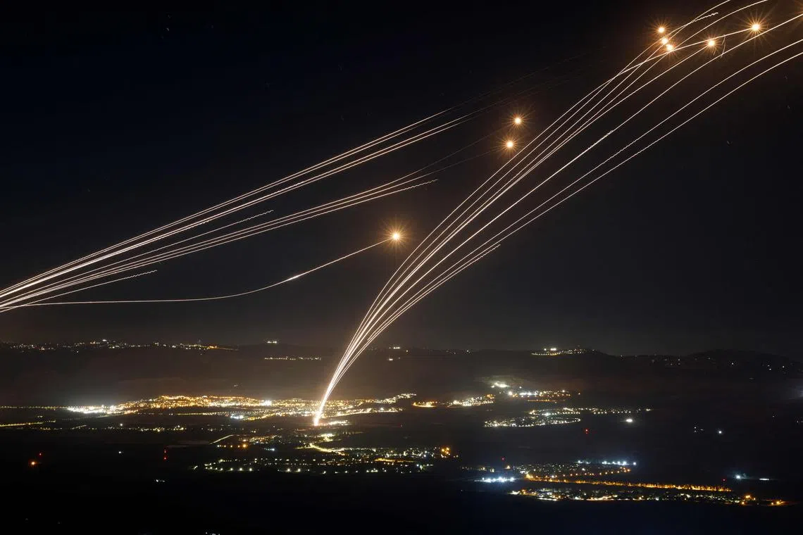 Rockets fired from southern Lebanon are intercepted by Israel's Iron Dome air defence system over northern Israel, on Aug 4, 2024.