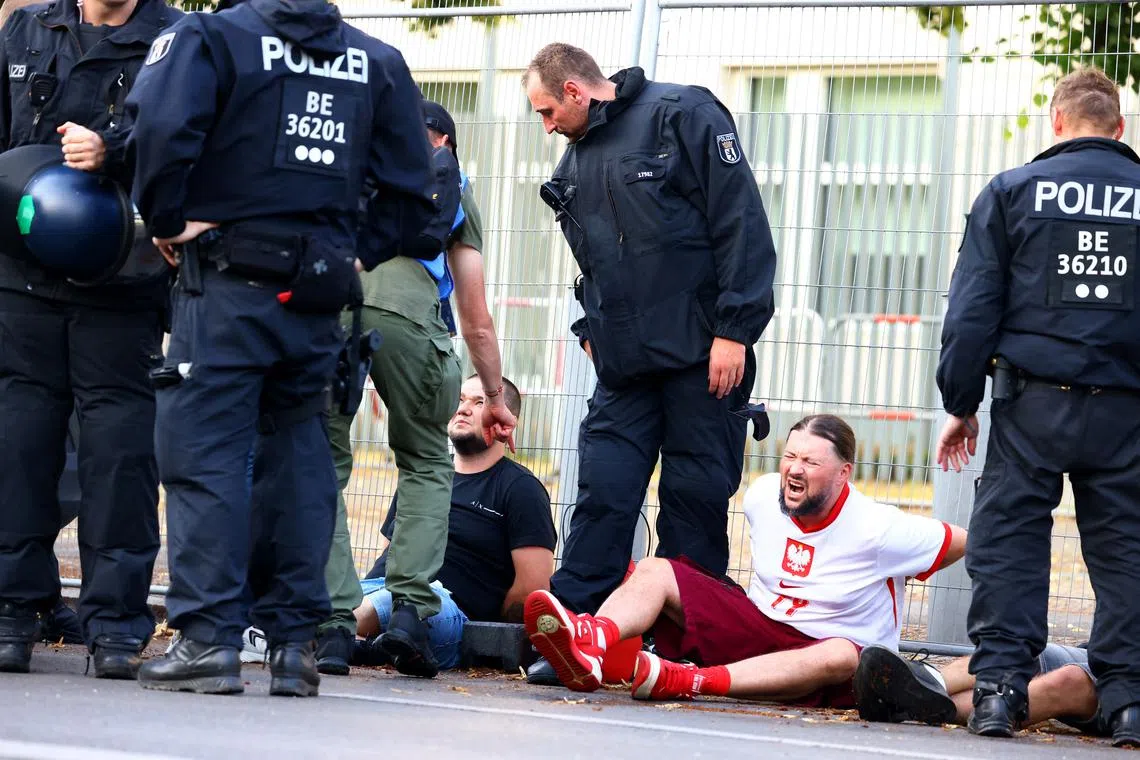 Soccer Football - Euro 2024 - Fans gather for Poland v Austria - Berlin, Germany - June 21, 2024 Poland fans are detained by police in Berlin after the match REUTERS/Nadja Wohlleben