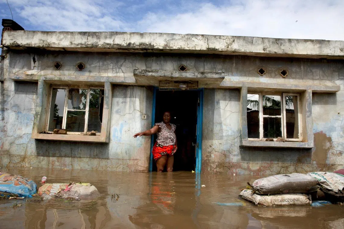 FILE PHOTO: A flood victim stands at her flooded home after weeks of heavy rainfall in Boane District, Maputo, Mozambique, January 19, 2026. REUTERS/Amilton Neves/File Photo
