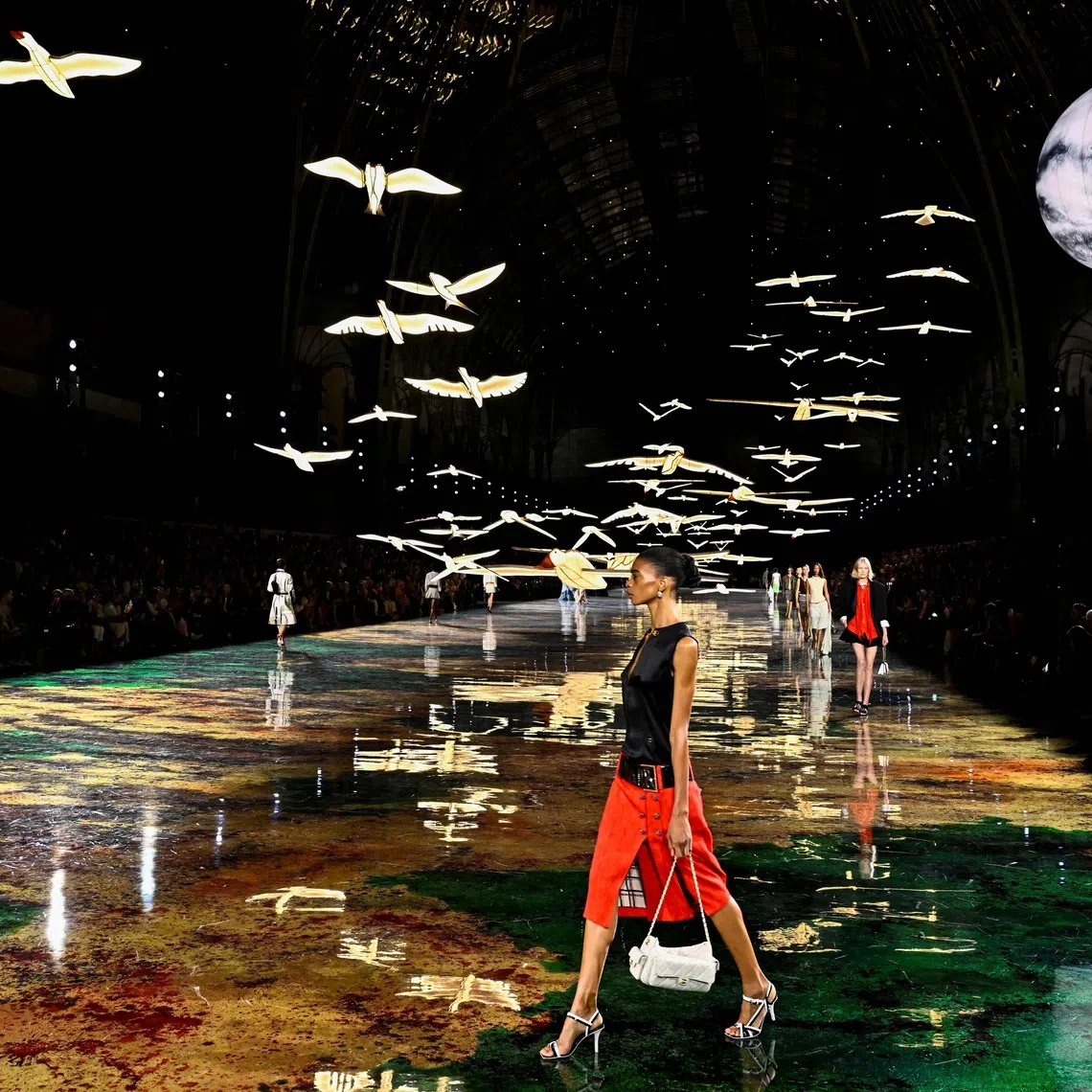 TOPSHOT - Models present creations for Chanel Women's Spring/Summer 2027 collection fashion show as part of the Paris Fashion Week, in Paris on October 5, 2026. (Photo by JULIEN DE ROSA / AFP)