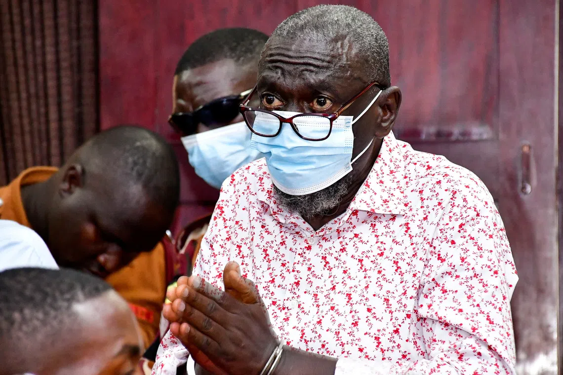 Detained Ugandan opposition figure Kizza Besigye gestures before he collapsed while attending a court session where he is on trial for treason, at the High court in Kampala, Uganda, July 29, 2026. REUTERS/Abubaker Lubowa