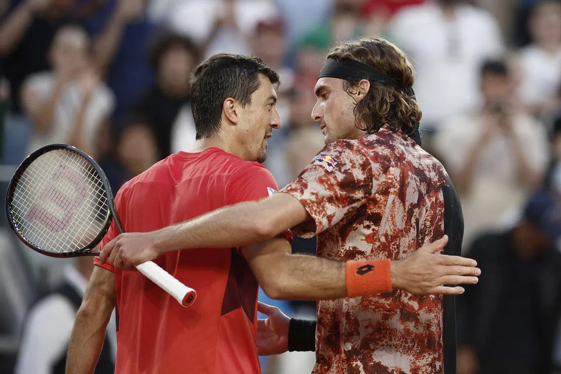 Greece's Stefanos Tsitsipas and Austria's Sebastian Ofner embrace after their fourth round match.