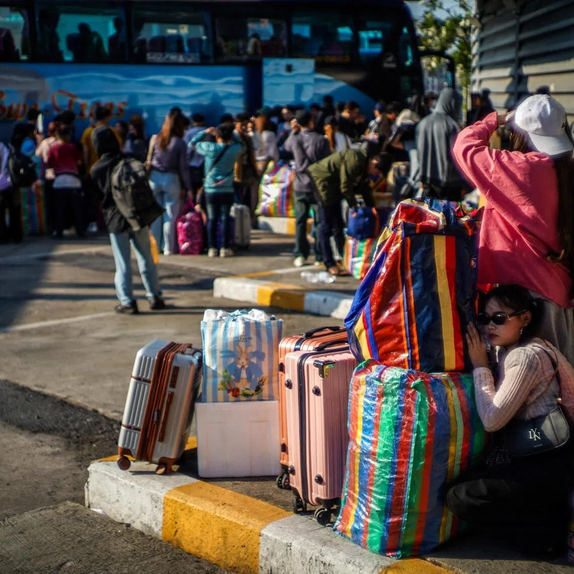 Travellers shelter behind belongings on April 10 at Mo Chit bus terminal in Bangkok, which is ranked the second-highest-risk city in the world for heat risk by Oxford University.