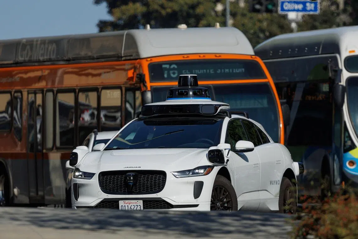 A Waymo driverless vehicle is pictured in the traffic, in downtown Los Angeles, California, U.S., October 2, 2024. REUTERS/Mike Blake