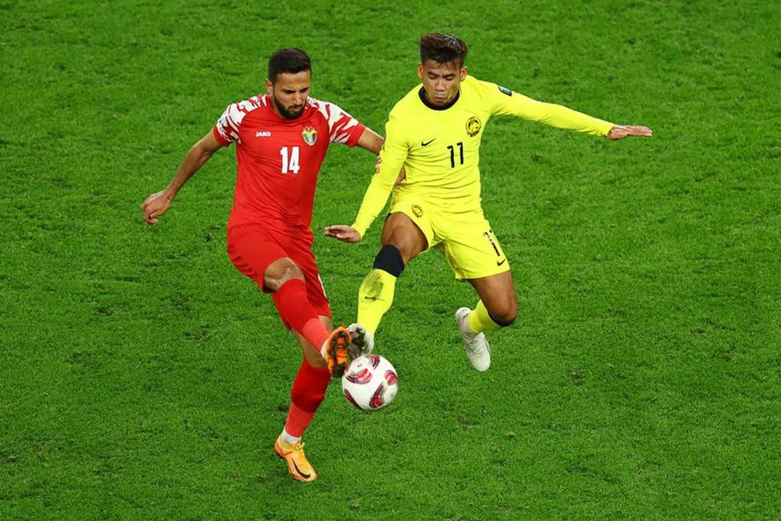 Soccer Football - AFC Asian Cup - Group E - Malaysia v Jordan - Al Janoub Stadium, Al Wakrah, Qatar - January 15, 2024  Jordan's Raja'ei Ayed in action with Malaysia's Safawi Rasid REUTERS/Molly Darlington