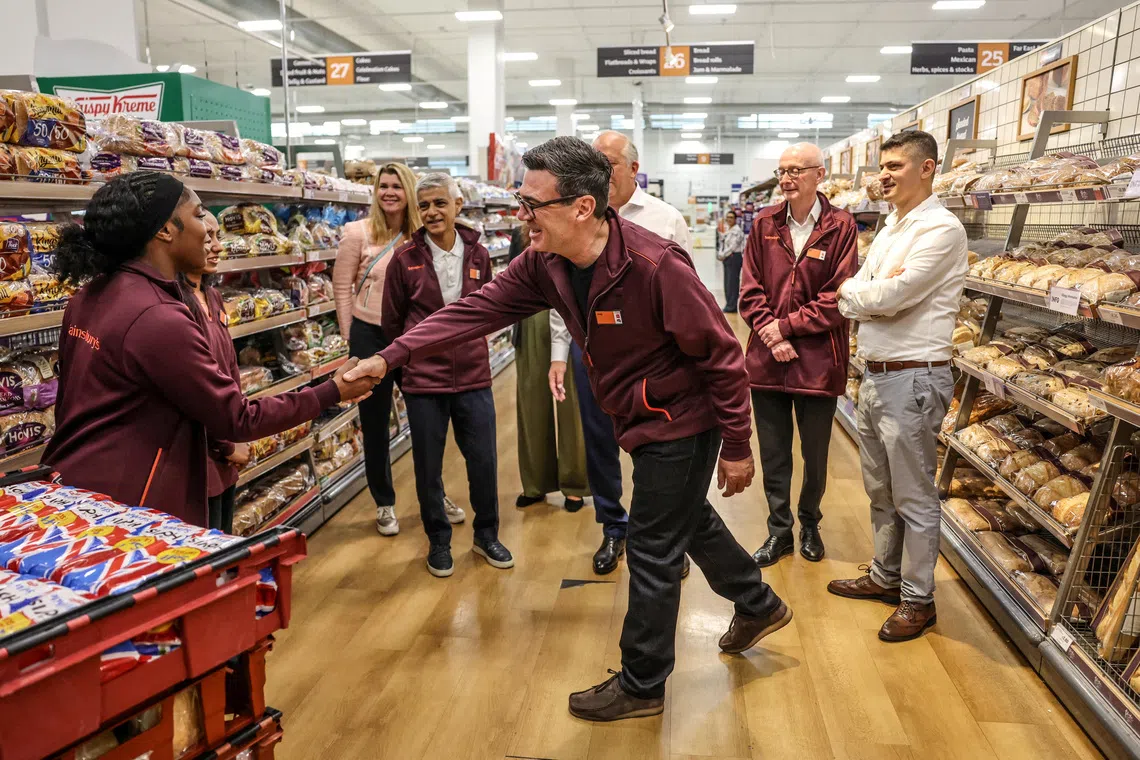 FILE PHOTO: Britain's Prime Minister Andy Burnham greets staff during a visit to a Sainsbury’s store with the Mayor of London Sadiq Khan and Pat McFadden Secretary of State for Work and Pensions, London, Britain, August 26, 2026.  Richard Pohle/Pool via REUTERS/File Photo