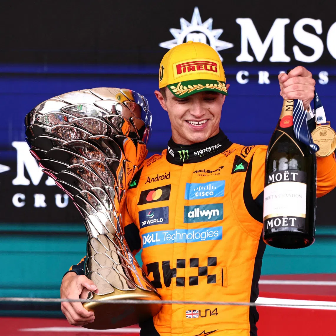 Formula One F1 - Sao Paulo Grand Prix - Autodromo Jose Carlos Pace, Sao Paulo, Brazil - November 9, 2025 McLaren's Lando Norris celebrates on the podium with a trophy after winning the Sao Paulo Grand Prix REUTERS/Jean Carniel