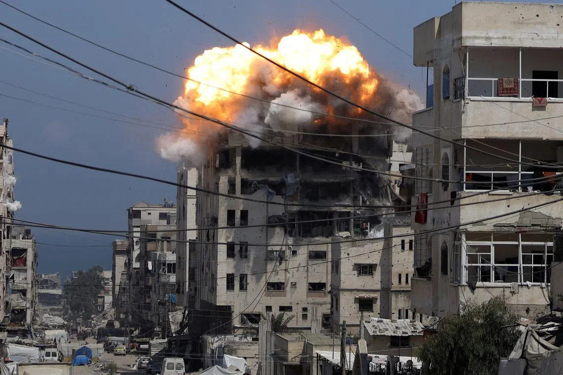 Smoke and flames rising from a residential building hit by an Israeli strike, in Gaza City, on July 21, 2025. 