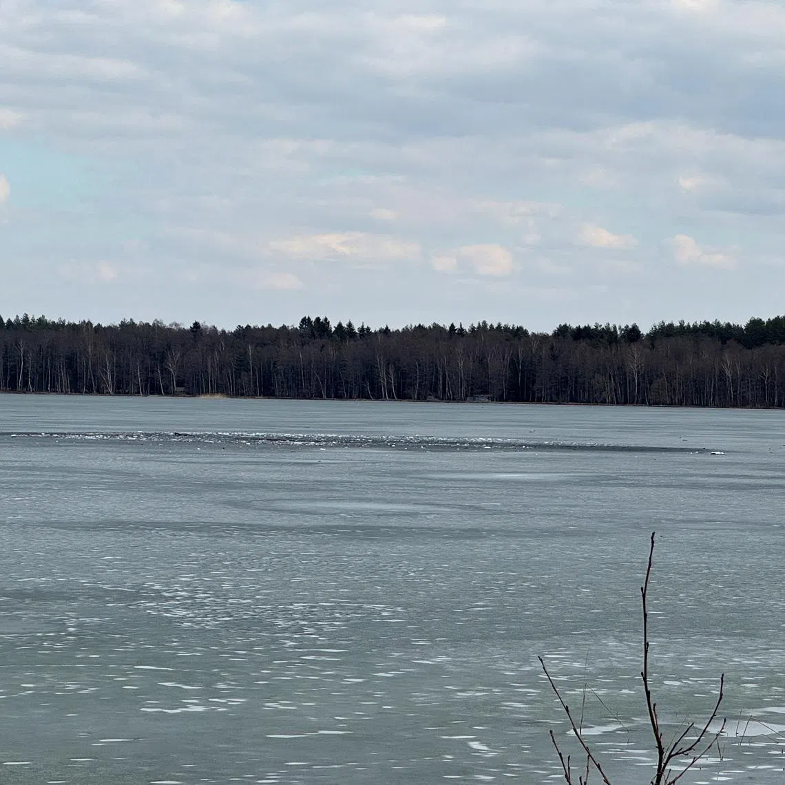 Debris lies across an ice-covered lake where Lithuania's army says that a suspected drone crashed into after entering the country's airspace, in Lavysas, Lithuania, March 23, 2026. Vytautas Lebednykas and Karolis Lebednykas/Handout via REUTERS