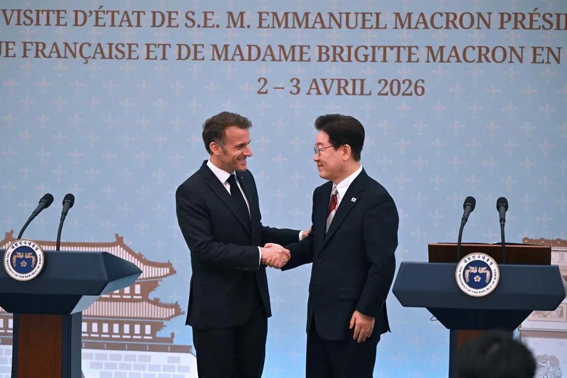 French President Emmanuel Macron (left) shaking hands with South Korean President Lee Jae Myung during a joint press conference in Seoul on April 3.