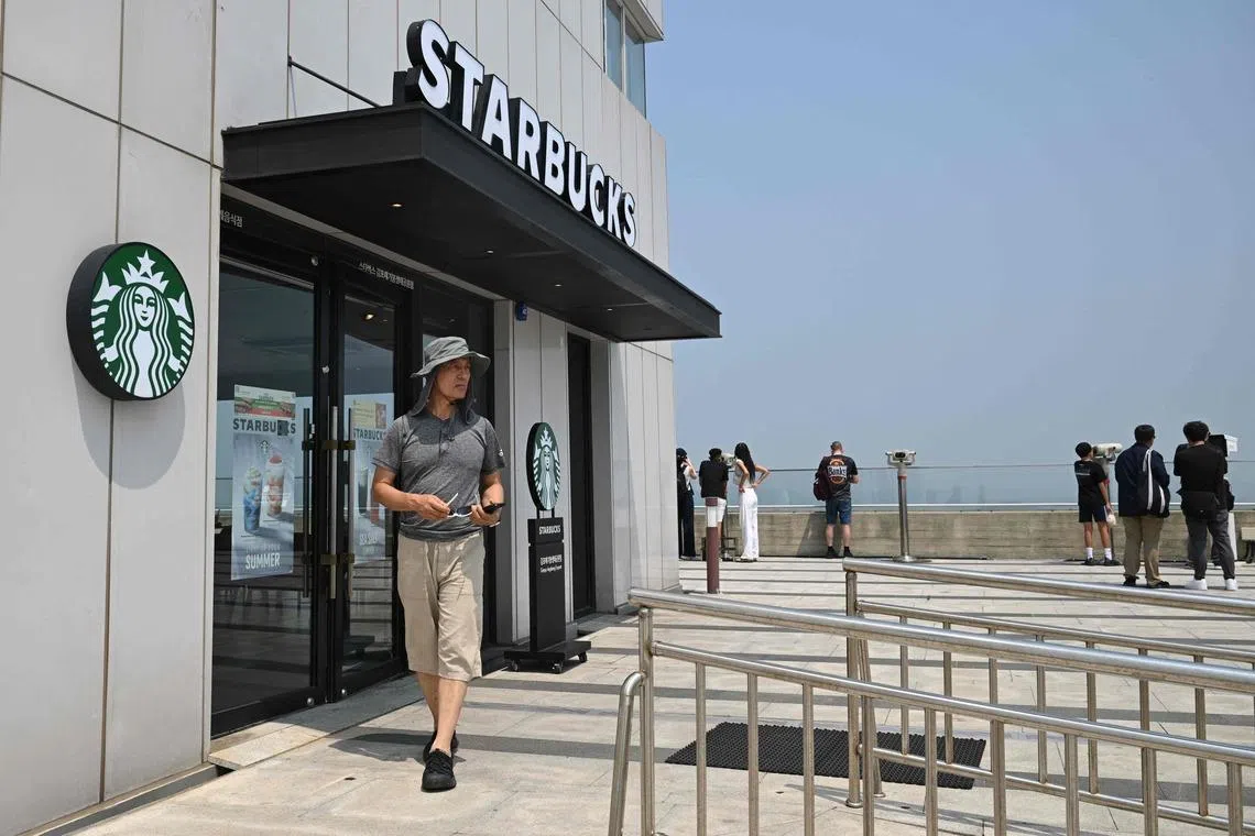 A visitor walks past a Starbucks store offering a view of North Korea at a South Korean observation deck at Aegibong Peace Ecopark in Gimpo on July 1.