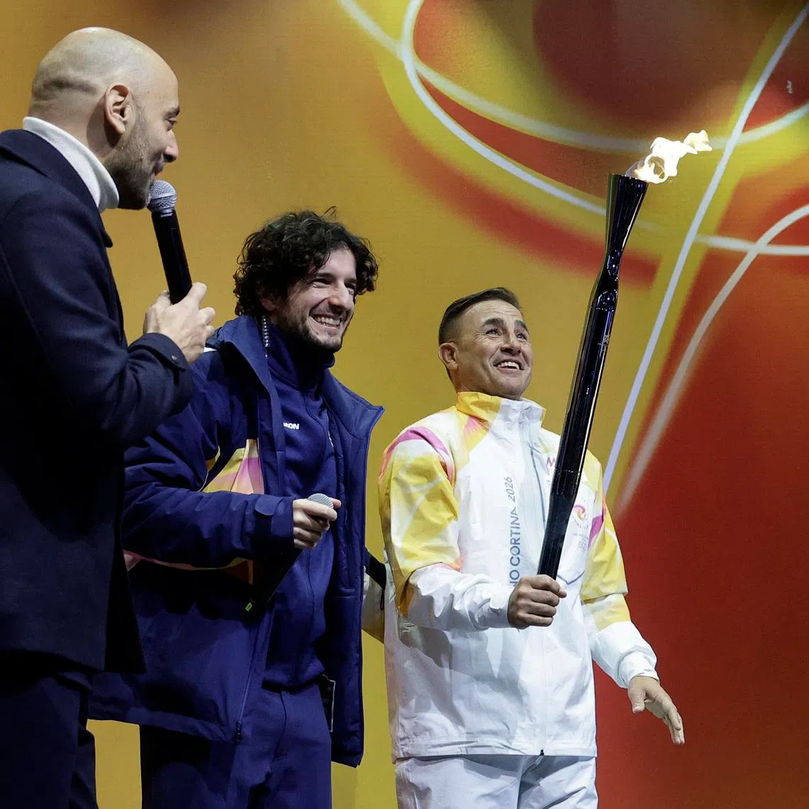 FILE PHOTO: 2026 Milano-Cortina Winter Olympics - 2026 Milano-Cortina Winter Olympics Torch Relay - Naples, Italy - December 23, 2025 Former Italian football player Fabio Cannavaro with the torch relay REUTERS/Ciro De Luca/File Photo