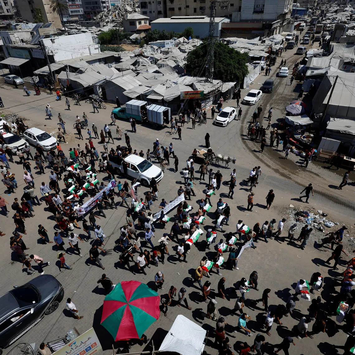 Palestinians attend the funeral of 50 people from three families killed during the war and whose bodies were retrieved from under the rubble recently, in Gaza City, August 20, 2026. REUTERS/Mahmoud Issa