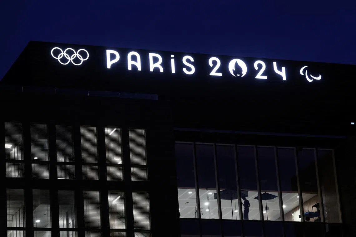 FILE PHOTO: The Olympics rings and the logos of the Paris 2024 Olympics and Paralympics Games are pictured on the Pulse building, the headquarters of the Paris 2024 Olympics organizing committee, in Saint-Denis near Paris, France, March 21, 2024. REUTERS/Stephanie Lecocq