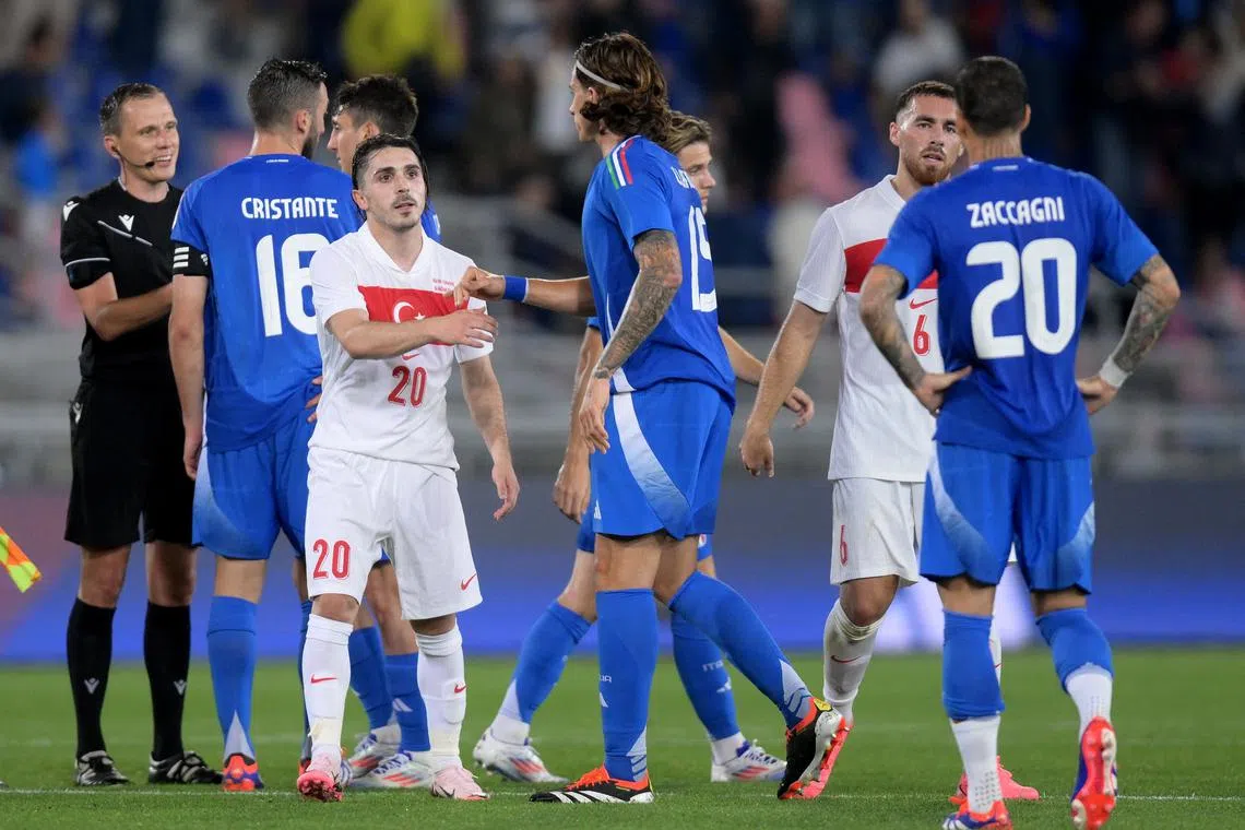 Soccer Football - International Friendly - Italy v Turkey - Stadio Renato Dall'Ara, Bologna, Italy - June 4, 2024 Turkey's Abdulkadir Omur shakes hands with Italy's Riccardo Calafiori after the match REUTERS/Daniele Mascolo
