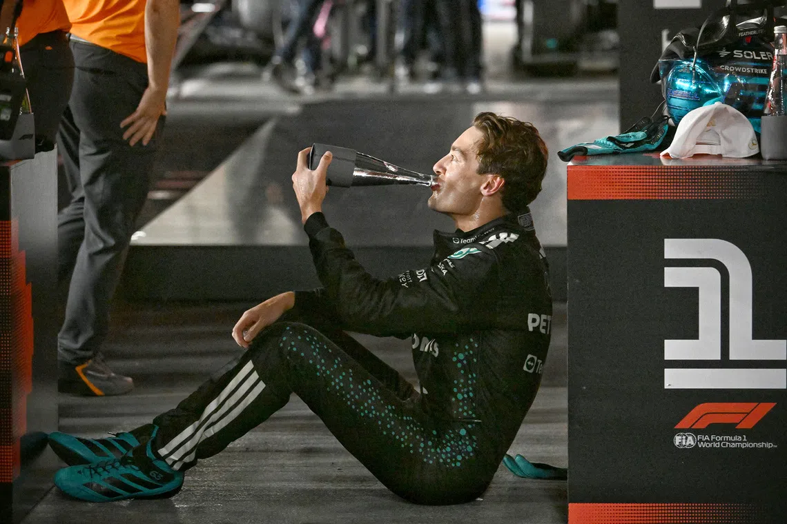 Mercedes' George Russell hydrating himself after 2025 Formula One Singapore Airlines Singapore Grand Prix at the Marina Bay Street Circuit on Oct 5, 2025. 