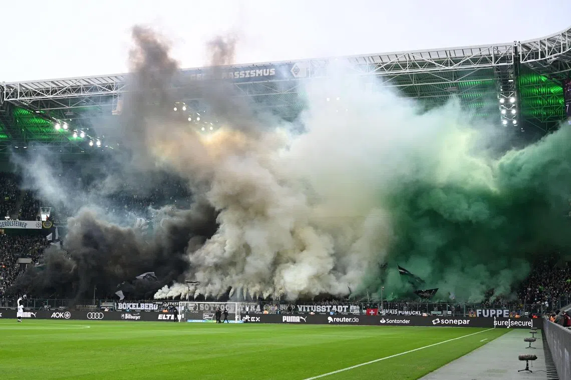 Moenchengladbach's supporters lighting flares prior the German first division Bundesliga football match between Borussia Moenchengladbach and Union Berlin in Moenchengladbach, western Germany on April 23, 2023. 