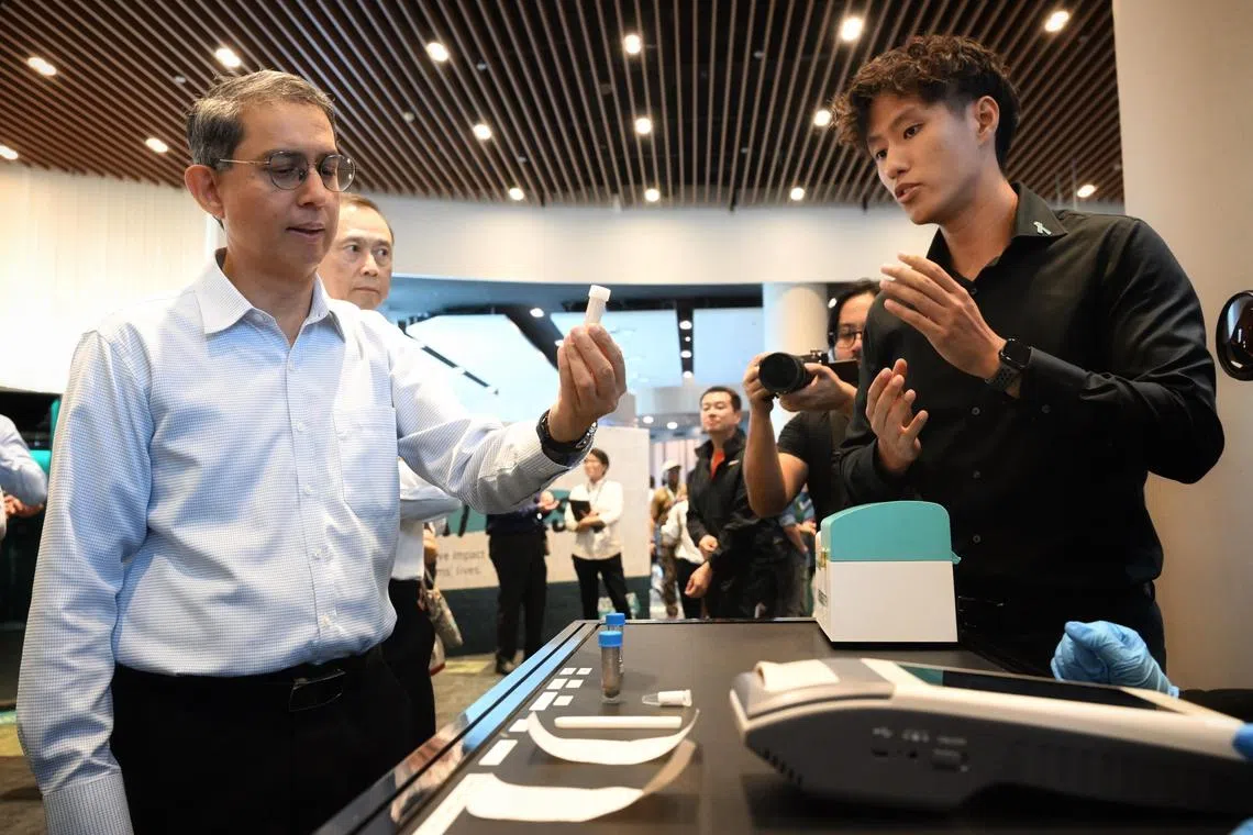 Slug: gwcnb10
ST PHOTO: Chong Jun Liang

Associate Professor Muhammad Faishal Ibrahim, Minister of State, Ministry of Home Affairs & Ministry of National Development taking a closer look at the Instant Hair Test Kit at the CNB Workplan Seminar on July 10, 2024.