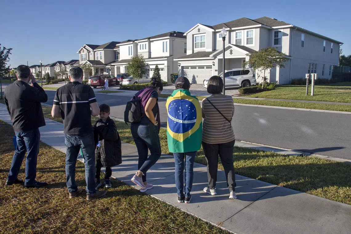 People stand in front of the house of former Brazil president Jair Bolsonaro in Florida on Jan 12, 2023.