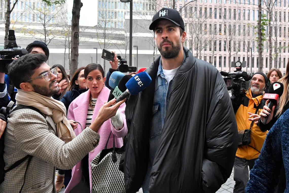 Spanish football player Gerard Pique leaving a court in Barcelona on Dec 1 after he attended the ratification of the separation demand with his ex-wife Colombian singer Shakira (not pictured) and the agreement on the custody of their children. 