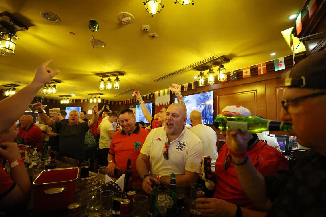 England fans at the Red Lion pub in Doha ahead of the Three Lions' game against the United States on Friday. 